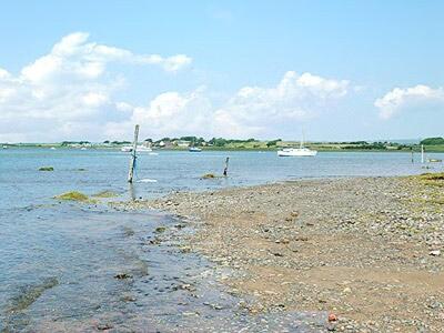 a body of water with a boat in the water at Ashlea in Ravenglass