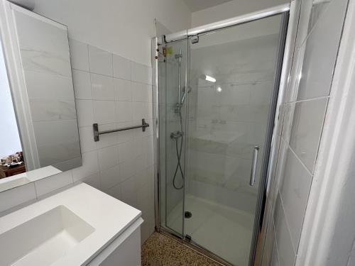 a bathroom with a glass shower and a sink at Maison Port-Vendres, 3 pièces, 4 personnes - FR-1-309-203 in Port-Vendres