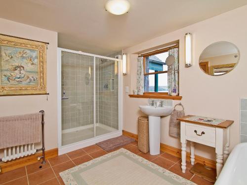 a bathroom with a sink and a shower at Rubha Lodge in Shieldaig