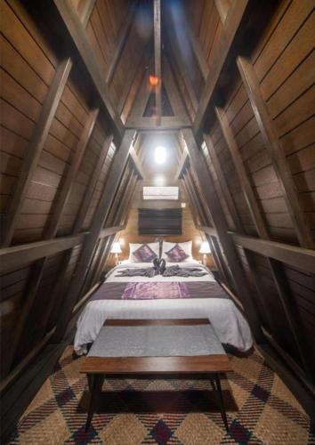 a room with a bed in a wooden attic at Rumah Kayu Tatiya Villa in Jimbaran