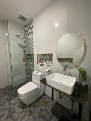a bathroom with a toilet and a sink and a mirror at Sea Smile Green View Pool Villa KRABI Klong Muang in Klong Muang Beach