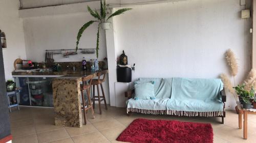 een woonkamer met een bank en een tafel bij Quitinete com piscina em Balneário Pinhal in Pinhal