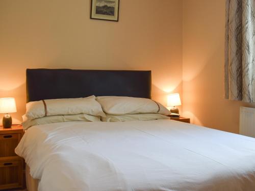 sypialnia z dużym białym łóżkiem z 2 lampami w obiekcie Elm Court 7 w mieście Keswick
