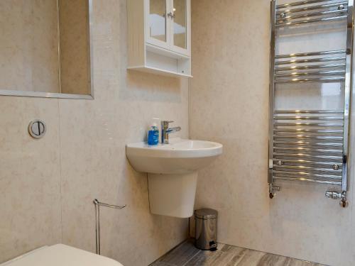 a bathroom with a sink and a toilet at Booth Farm Cottage in Buxton