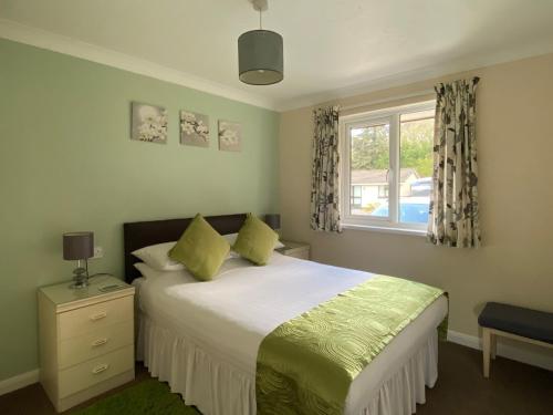 a bedroom with a large bed and a window at Tresco - B6520 in Saint Cleer