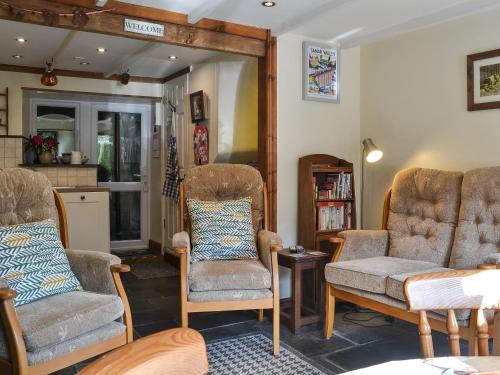 a living room with two chairs and a couch at The Bolthole - 28188 in Yelverton