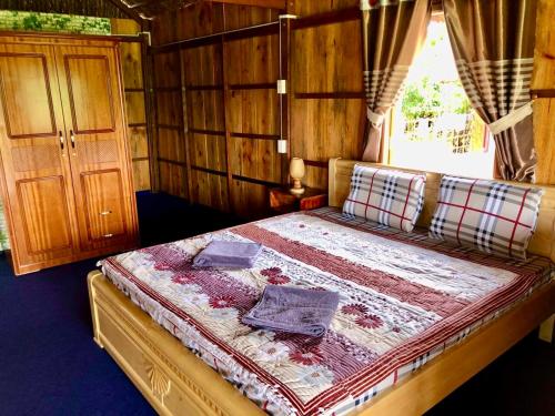 a bedroom with a bed in a wooden room at Discovery Mekong local's life - Breakfast TwoBoatTours Included for 2nights in Can Tho