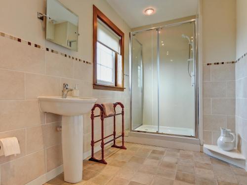 W łazience znajduje się umywalka i prysznic. w obiekcie The Cottage w mieście Girvan