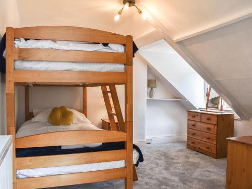 a bedroom with two bunk beds in a attic at Church View in Lynmouth