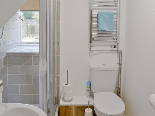 a bathroom with a toilet and a sink at The Old Sweet Shop in Hook Norton