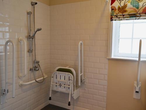 a bathroom with a walk in shower and a walk in shower at The Garden Cottage in Rudston