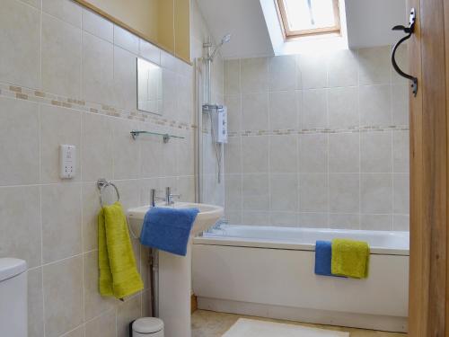 a bathroom with a tub and a sink at Gorsddu in Llanwrthwl