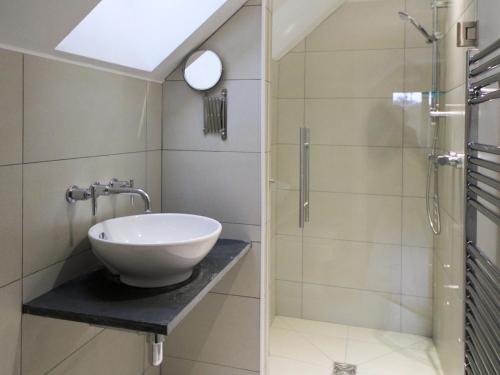 a bathroom with a sink and a shower at Caracol - Cccf in Wroxham
