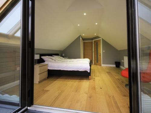 a bedroom with a bed in a attic at Caracol - Cccf in Wroxham