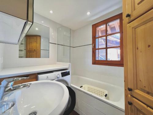 a white bathroom with a sink and a tub at Appartement spacieux 8 pers, village, parking, fibre - FR-1-505-183 in Notre-Dame-de-Bellecombe