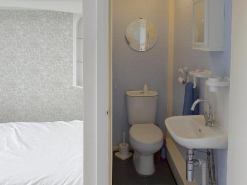 a bathroom with a toilet and a sink at Rossall Beach Cottage in Cleveleys