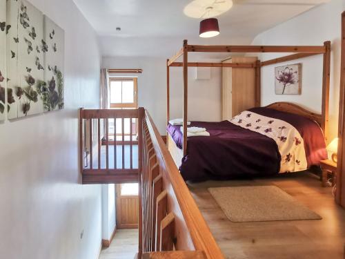 a bedroom with a bunk bed and a staircase at The Calf Shed in Alston