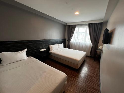 Postel nebo postele na pokoji v ubytování Signature Hotel