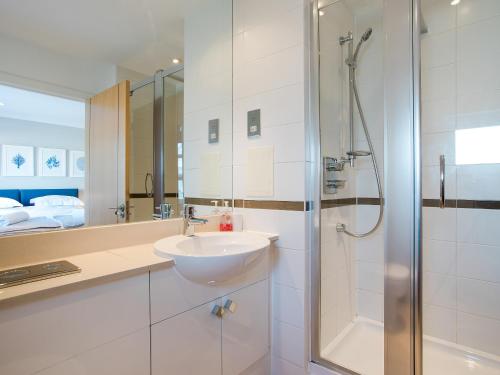 a bathroom with a sink and a shower at 16 Marinus in Cowes