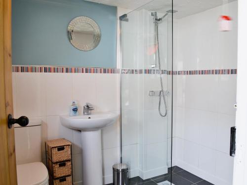 a bathroom with a sink and a shower at Little Tern in Winterton-on-Sea