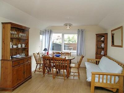 a living room with a table and a couch at Brecklands in Scratby