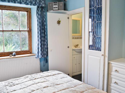 a bedroom with a bed and a sink and a window at The Old Mill in Bucks Mills