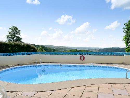a large swimming pool in the middle of a patio at Beaford House in Beaford