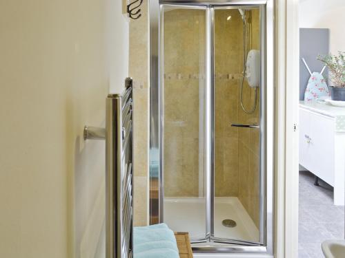 a shower with a glass door in a bathroom at Ivy House in Saint Annes on the Sea