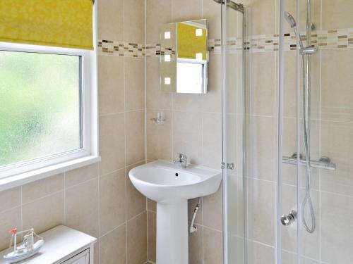 a bathroom with a sink and a shower at Watersmeet in Looe