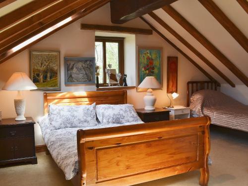 a bedroom with a large wooden bed and two lamps at Kris Kin in Brynkir