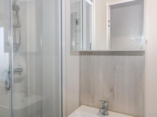 a bathroom with a sink and a shower at The Retreat in Budleigh Salterton