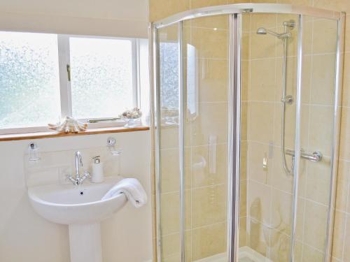 a bathroom with a shower and a sink at The Old Barn - 28971 in Selstead