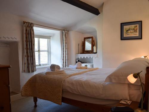 a bedroom with a bed with two towels on it at Foss Gill in Starbotton
