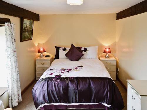 a bedroom with a bed and two night stands at Moorland Retreat in Barbrook