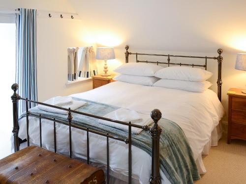 sypialnia z dużym łóżkiem z białą pościelą i poduszkami w obiekcie The Fish House w mieście Rispond