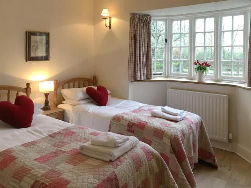 a bedroom with two beds with towels on them at Overwater Lodge in Bassenthwaite Lake