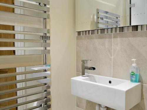 布雷思韋特的住宿－The Larches，浴室设有白色水槽和镜子