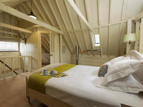 a bedroom with a large bed in a room at The Dairy in Heveningham