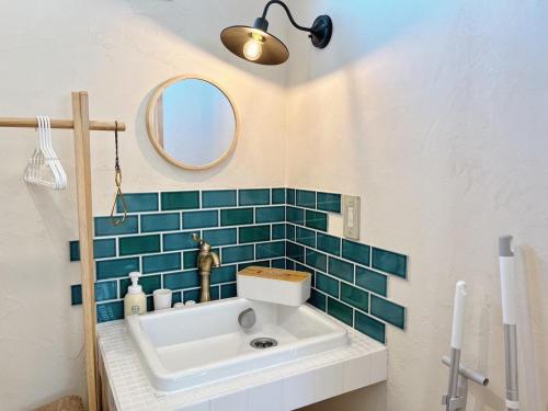 a bathroom with a sink and a mirror at 小さな森の貸し切り宿Forest-House-Ranapirica in Shibetsu