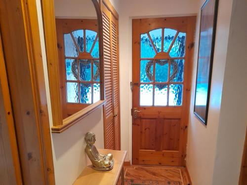 a bathroom with a sink and a door with windows at Croiscrag Cottage in Aboyne