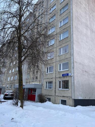 a tall building with snow in front of it at Prisma Apartment in Tallinn