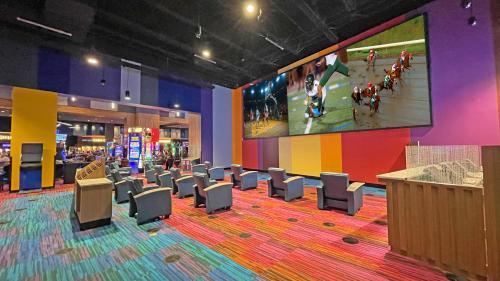 a large room with chairs and a large screen at Harrah's Cherokee Valley River, A Caesars Destination in Murphy