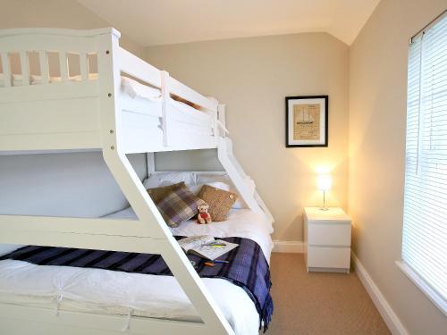 a bedroom with a bunk bed with a ladder at Ardbhan Croft in Oban