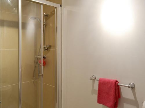 a shower with a glass door and a red towel at Townfield Farm in Chinley