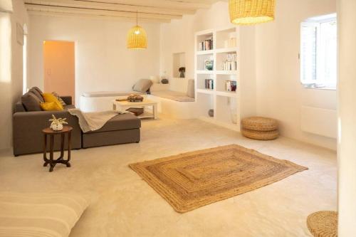 a living room with a couch and a table at Cycladic Villa Kamari in Kampos Paros