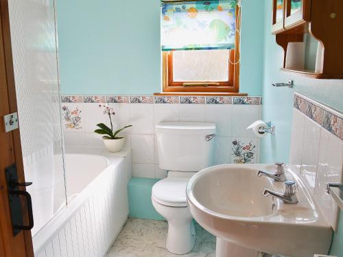 a bathroom with a toilet and a sink at Eaton Barn in Burmarsh