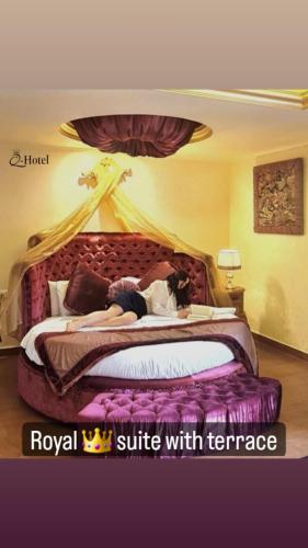 a woman laying on a bed in a hotel room at Q Hotel in Beirut