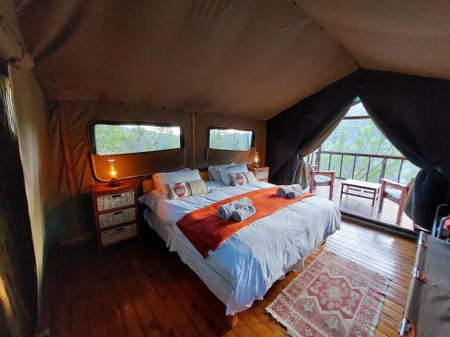 a bedroom with a bed in a tent at Agama Tented Camp in Garies