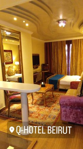 a hotel room with a hotel bed and a table at Q Hotel in Beirut
