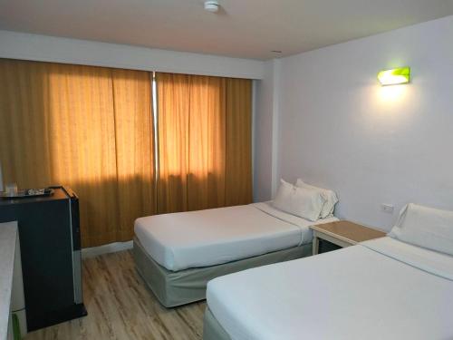 Ένα ή περισσότερα κρεβάτια σε δωμάτιο στο INTERTOWER HOTEL (SHA)